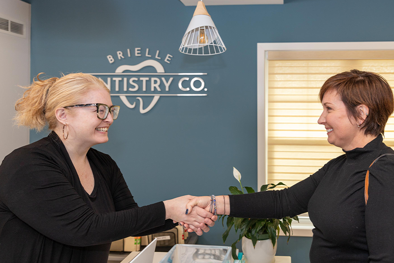staff member greeting patient at the front desk